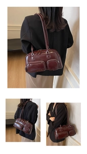 Detail view of vintage dark red glossy leather shoulder bag with functional dual pockets