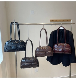 Detail view of stylish bowling handbags in four colors with functional front zipper pockets