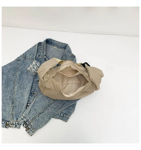 Internal view of large khaki nylon tote bag showing spacious main compartment and pockets