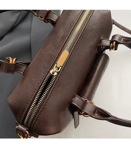 Detail of smooth golden zipper and vintage leather texture on retro shoulder bag