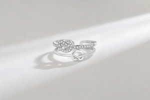 Detailed view of silver knot ring with sparkling zircon pavé and polished metal band