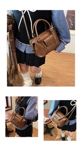 Close-up of vintage brown crossbody bag showing faux leather texture and magnetic flap pocket
