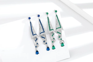 Detailed view of silver geometric teardrop earrings in royal blue and emerald green sets
