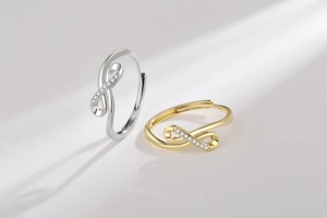 Detailed view of silver and gold infinity rings with sparkling micro-pave crystals