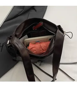 Top view of spacious brown tote interior showing phone, umbrella and zipper pocket