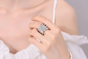 Macro detail of gothic silver spider ring with sparkling zircon stones on finger