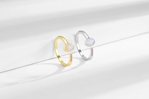 Detailed macro of minimalist gold and silver rings with opal and pink gemstones