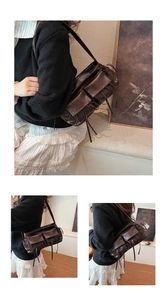 Detail of vintage brown shoulder bag with multiple flap pockets and drawstring accents