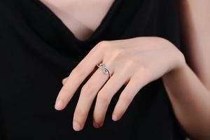 Macro detail of infinity symbol ring with silver metal finish and cubic zirconia inlay