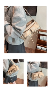 Detail of beige faux leather shoulder bag with functional multi-pockets and lace-up straps