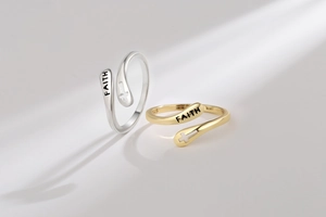 Macro detail of S925 sterling silver cross ring with Faith engraving and gold plating