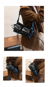 Detailed macro view of black multi-pocket underarm bag with glossy faux leather texture