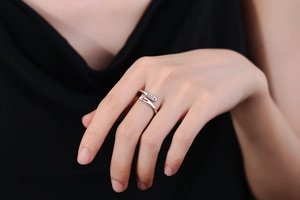 Macro shot of silver Faith ring with hollow cross and engraved lettering on finger