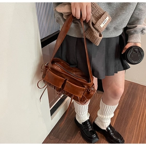 Brown retro multi-pocket shoulder bag with drawstring detail and vintage aesthetic