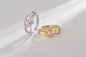 Detail of pink heart-shaped zircon rings with adjustable bands and micro-paved gems