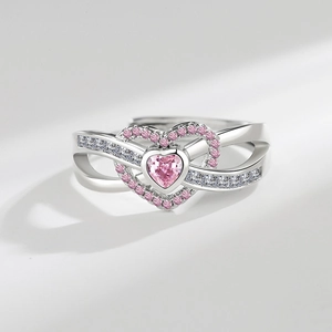 Macro shot of silver ring with pink heart gemstone and twisted pave set bands