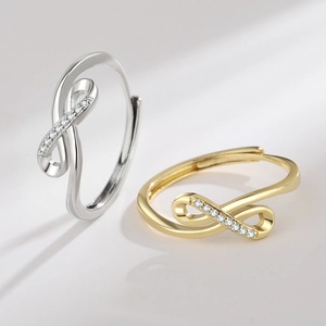 Minimalist infinity rings in gold and silver colors with shimmering pavé crystal setting