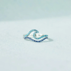 Close-up of double layer wave ring with gradient blue crystals in silver setting