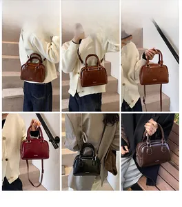 Detail view of stylish Boston bags in brown, wine red, black and dark coffee colors