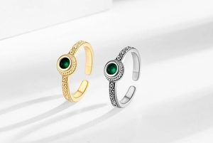 Retro rings with textured scroll patterns and green round center stones in gold and silver