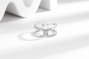 Macro shot of silver knot ring featuring micro-paved cubic zirconia stones and an open design