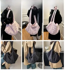 Detail of heart quilted patterns on large capacity commuter tote bags in black and pink
