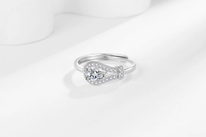 Macro detail of silver ring with pear-shaped zircon and pave set diamonds in soft light