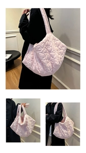 Detail of light pink tote bag with heart-shaped quilted pattern and soft fabric texture