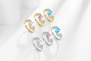 Detailed view of leaf-shaped rings set with oval colorful gemstones in gold and silver