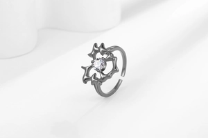 Macro detail of gothic thorn open ring with a sparkling round zircon in gunmetal finish