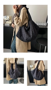 Detail view of black heart-quilted puffer tote bag featuring spacious interior for commute