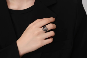 Detail of gothic black thorn ring with sparkling center rhinestone worn by a model