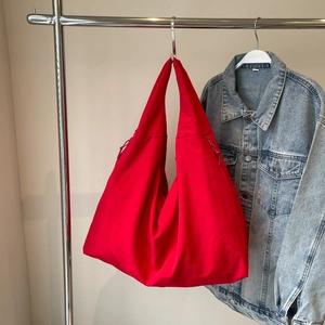 Lightweight red nylon puff shoulder bag with pleated texture and drawstring details