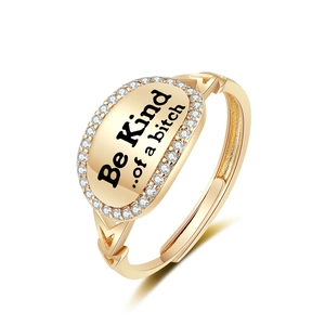 Gold oval signet ring with Be Kind engraving and sparkling zircon border detail