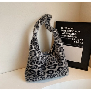 Detail of soft leopard print faux fur texture on a grey hobo shoulder tote bag