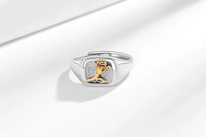 Macro detail of adjustable square ring with golden 3D rose relief and frosted texture