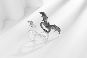 Detailed close-up of Gothic bat rings in silver and antique finish with adjustable bands