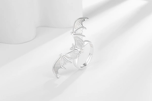 Detailed close-up of gothic silver bat open ring with intricate wing textures