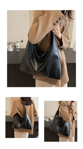 Detail of a large black oil-wax leather tote bag showing soft texture and hobo design