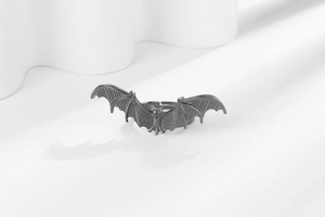 Macro detail of gothic bat ring with textured wings and vintage silver finish