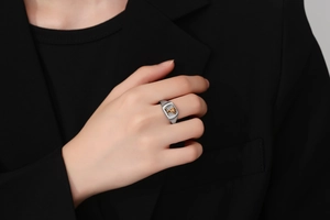 Close-up of vintage signet ring with gold animal relief on a square silver band