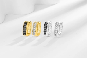 Detailed close-up of U-shaped hoop earrings with baguette stones and hollow grid patterns