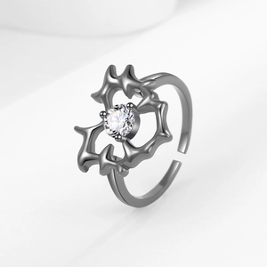 Gothic thorn heart ring with sparkling rhinestone star detail in dark metal finish