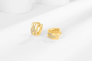 Détails de boucles d'oreilles huggie dorées au design géométrique avec incrustation zircon