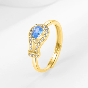 Elegant gold open ring featuring a pear-cut blue zircon and pavé crystal accents