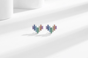 Macro shot of 925 silver pixel heart stud earrings with rainbow gradient cubic zirconia