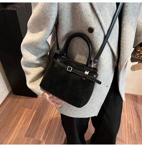 Black matte leather mini tote bag with silver buckle and detachable shoulder strap