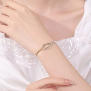 Elegant two-tone knotted snake chain bracelet for couples shown on a model wrist