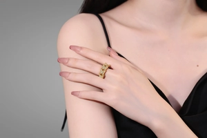 Detail of a gold-plated double-layer butterfly ring with sparkling cubic zirconia on a model