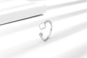 Detail shot of a minimalist S925 silver four-leaf clover adjustable ring with a white shell inlay